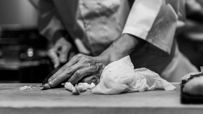 A chef's hand at work, in quiet focus